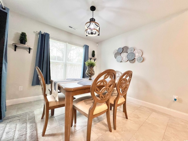 dining area with an inviting chandelier