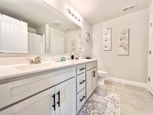 bathroom with vanity, toilet, and tile patterned flooring