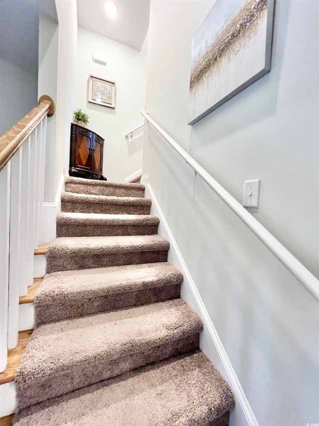 staircase featuring wood-type flooring