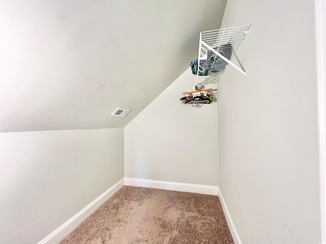 interior space featuring carpet and lofted ceiling