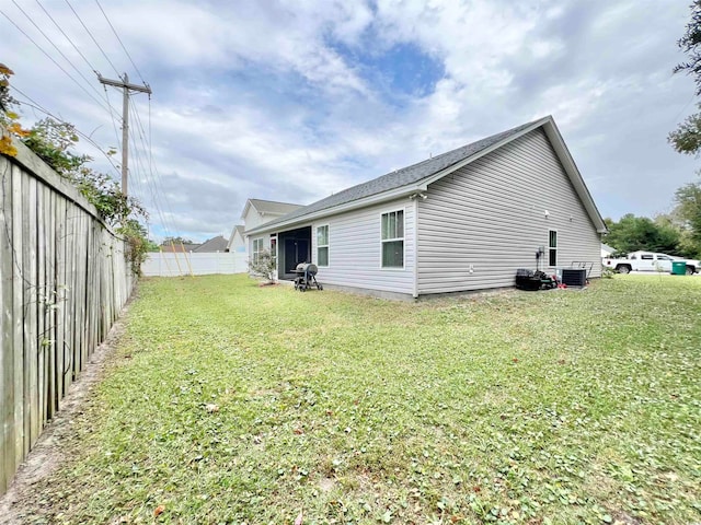 view of side of property with a lawn