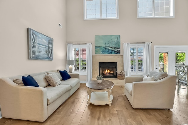 1002 Summers Pl, North Myrtle Beach, SC 29582 - living room with a high ceiling, a lit fireplace, wood finished floors, and visible vents