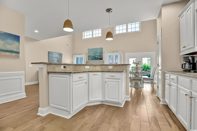 1002 Summers Pl, North Myrtle Beach, SC 29582 - kitchen featuring white cabinets, pendant lighting, and light wood-type flooring