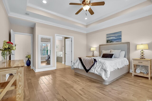 1002 Summers Pl, North Myrtle Beach, SC 29582 - bedroom featuring crown molding, a tray ceiling, and light wood-type flooring