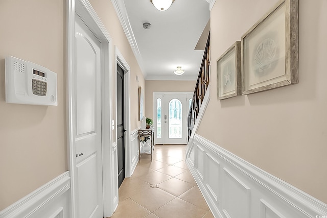 1002 Summers Pl, North Myrtle Beach, SC 29582 - entryway with ornamental molding, light tile patterned flooring, a decorative wall, wainscoting, and stairs