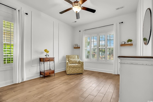 1002 Summers Pl, North Myrtle Beach, SC 29582 - living area featuring light wood-type flooring, visible vents, baseboards, and ceiling fan