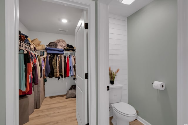 bathroom with toilet and hardwood / wood-style floors