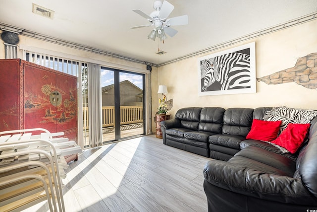 living room featuring ceiling fan and light wood-type flooring