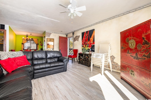 living room featuring light hardwood / wood-style floors and ceiling fan