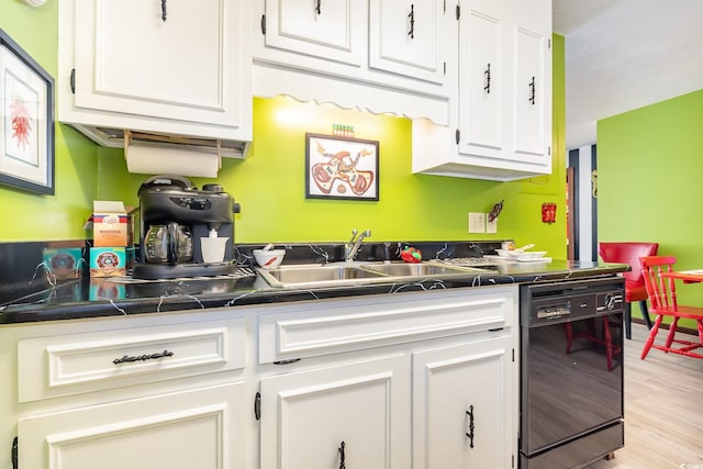 kitchen with sink, dishwasher, white cabinetry, and light hardwood / wood-style floors