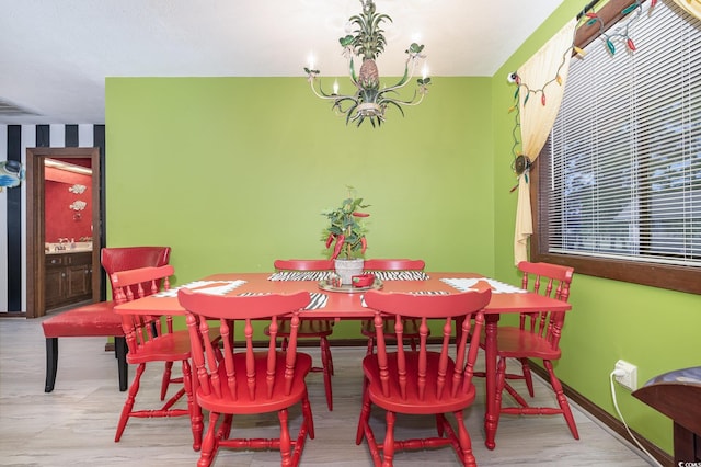 dining room featuring light hardwood / wood-style floors and an inviting chandelier