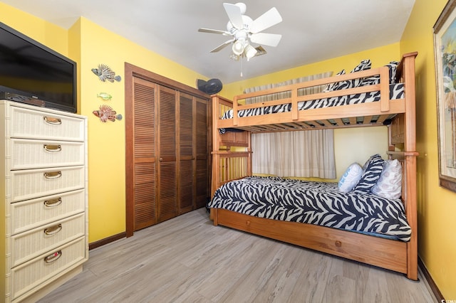 bedroom featuring light hardwood / wood-style flooring, a closet, and ceiling fan