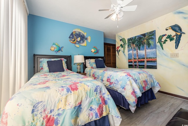 bedroom with ceiling fan and hardwood / wood-style floors