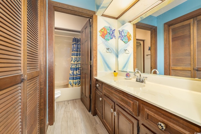 full bathroom with toilet, vanity, shower / bathtub combination with curtain, and wood-type flooring