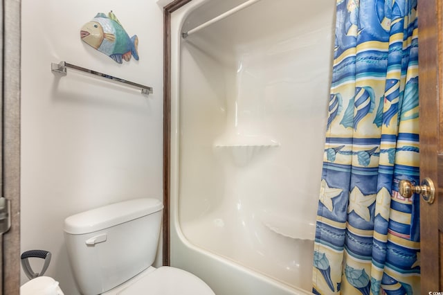 bathroom with shower / bath combination with curtain and toilet