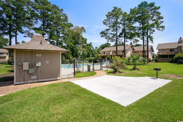 view of property's community featuring a yard and a pool