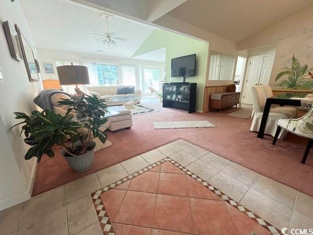 living room featuring lofted ceiling, carpet, and ceiling fan