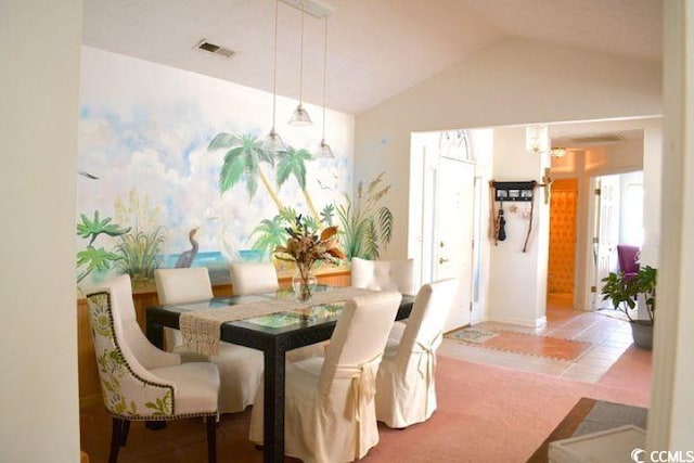 tiled dining area with lofted ceiling