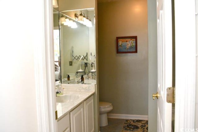 bathroom featuring vanity, toilet, and tile patterned flooring