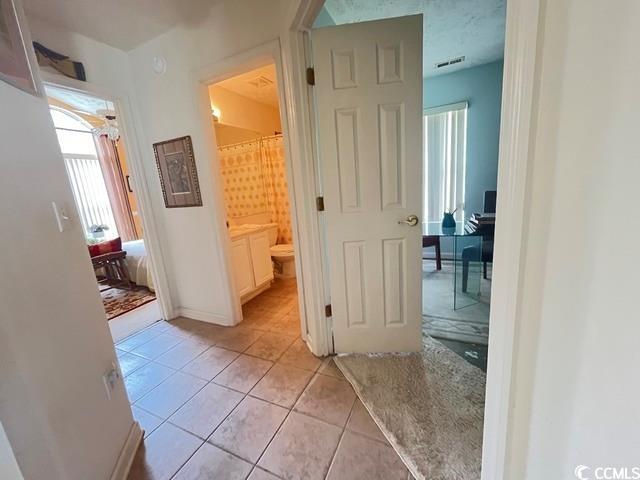 hallway featuring light tile patterned flooring