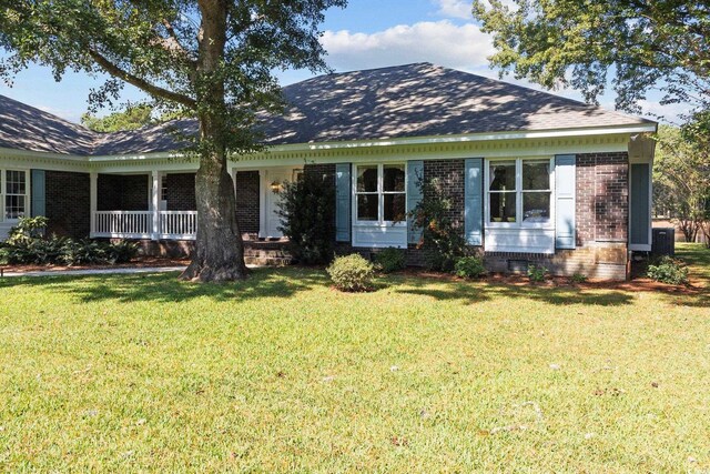 ranch-style house with a front yard and a porch