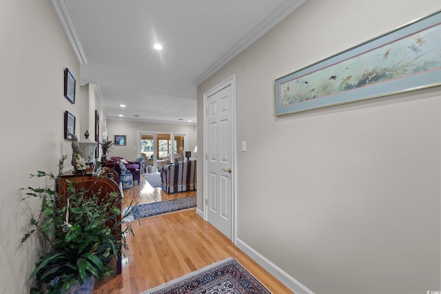 hallway with hardwood / wood-style floors and crown molding