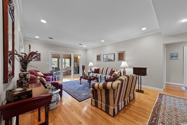 living room with crown molding and light hardwood / wood-style floors