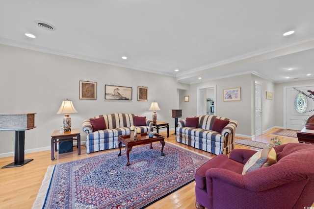 living room featuring light hardwood / wood-style flooring and ornamental molding