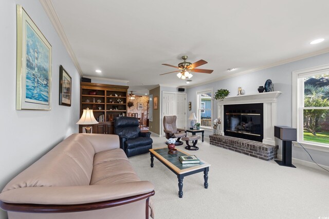 living room featuring crown molding, a fireplace, and carpet flooring