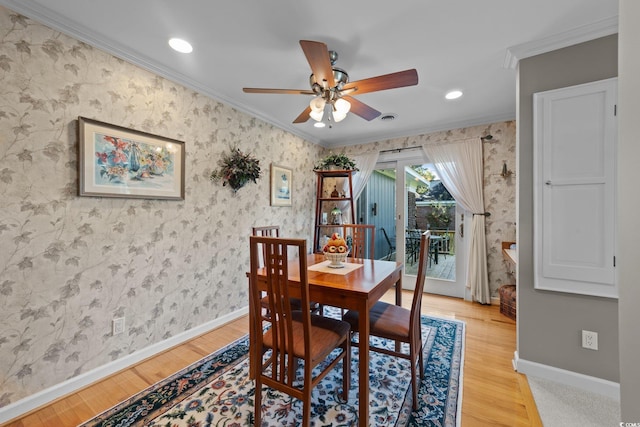 dining room featuring wood-type flooring, ornamental molding, and ceiling fan