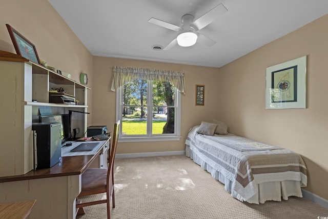 bedroom with ceiling fan and light carpet