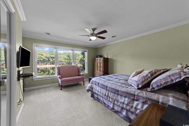 bedroom featuring crown molding, light colored carpet, and ceiling fan