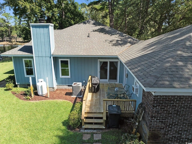 back of house featuring a wooden deck, a yard, central AC unit, and a wall unit AC