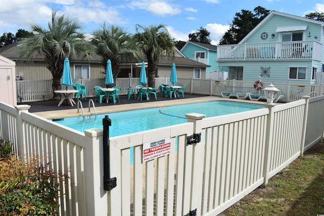 view of swimming pool with a patio