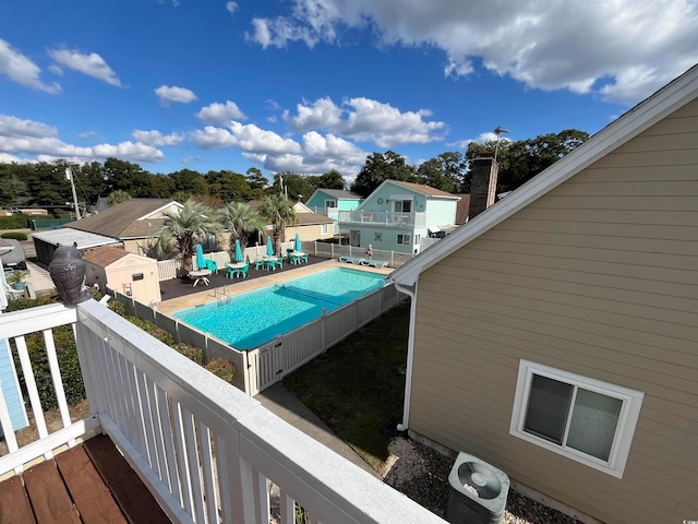 view of swimming pool with central AC unit