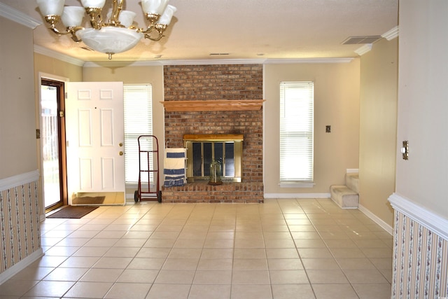 unfurnished living room featuring ornamental molding, a chandelier, a brick fireplace, and light tile patterned floors