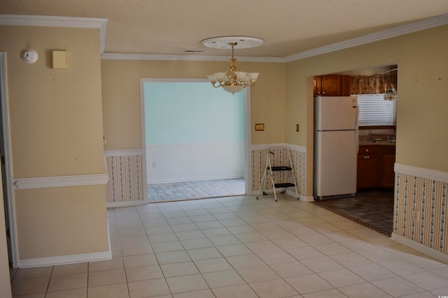 interior space with crown molding, a textured ceiling, a chandelier, and light tile patterned floors