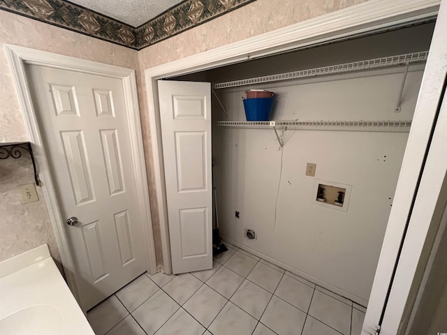 clothes washing area with hookup for an electric dryer, light tile patterned floors, laundry area, and hookup for a washing machine