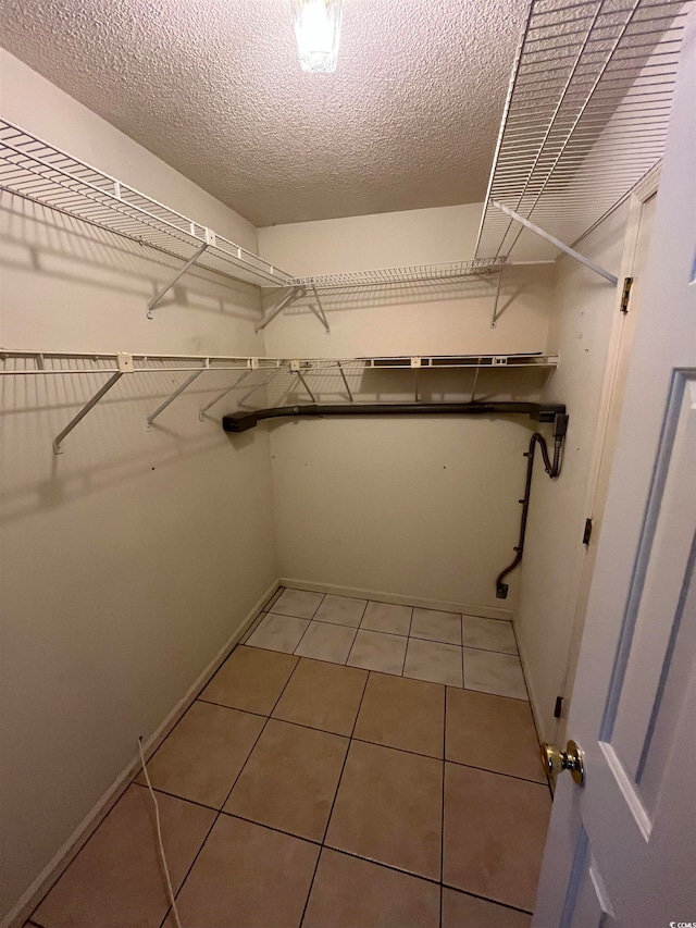 spacious closet with light tile patterned flooring