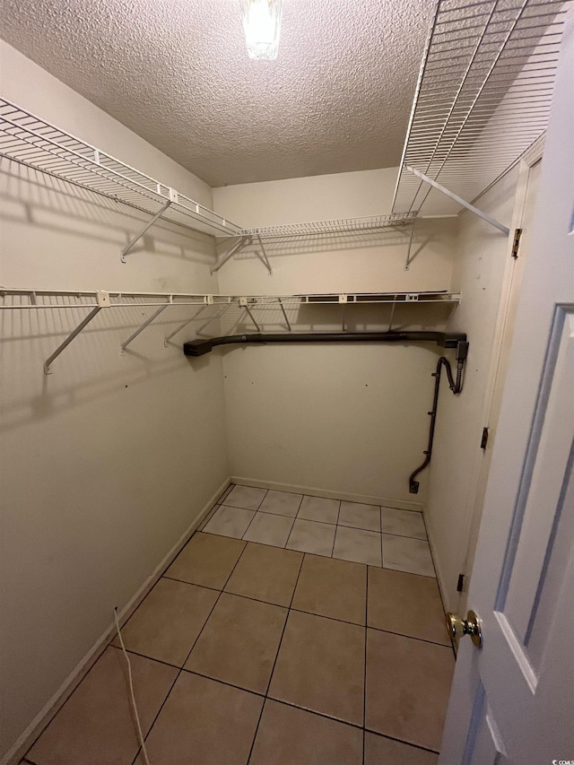 spacious closet featuring light tile patterned floors