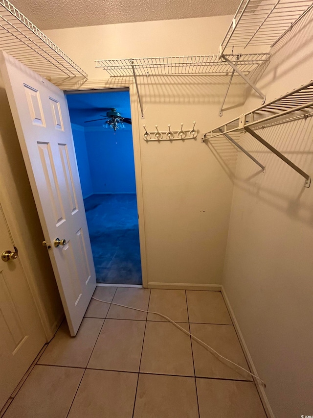 spacious closet featuring tile patterned floors and ceiling fan