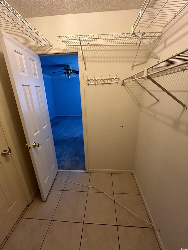 spacious closet with tile patterned floors