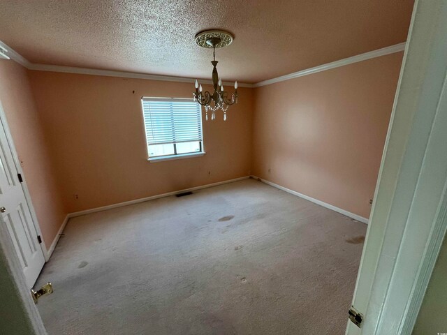 unfurnished dining area featuring ornamental molding, a notable chandelier, a textured ceiling, and light colored carpet