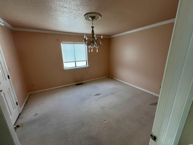 spare room featuring a chandelier, light colored carpet, baseboards, and ornamental molding