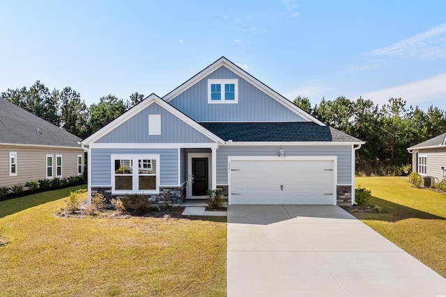 craftsman inspired home featuring central air condition unit, a front yard, and a garage