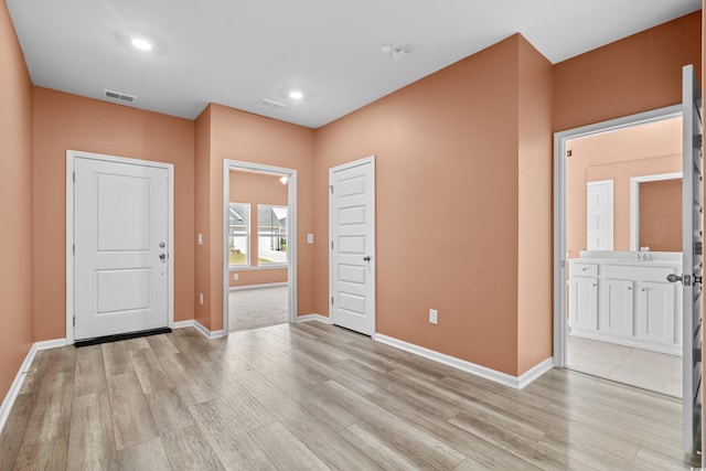 entrance foyer featuring light wood-type flooring and sink