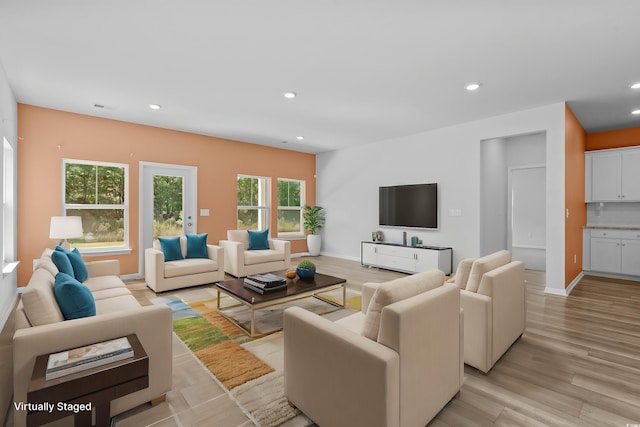 living room featuring light hardwood / wood-style floors and a wealth of natural light