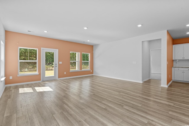 unfurnished living room with light hardwood / wood-style floors