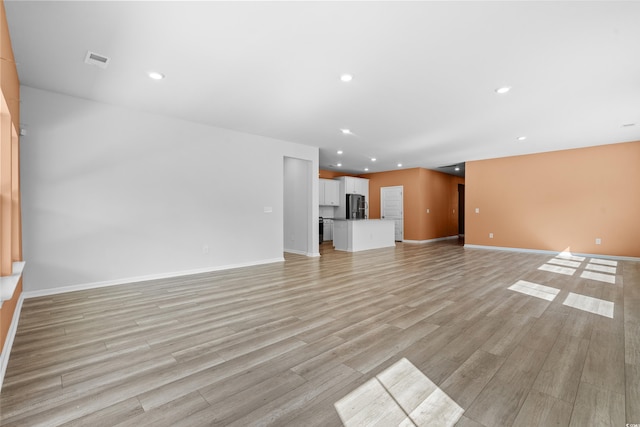 unfurnished living room with light hardwood / wood-style flooring