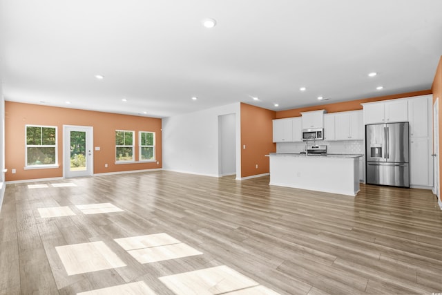 unfurnished living room with light hardwood / wood-style floors